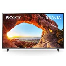 تصویر تلویزیون Sony Bravia با نمایش یک منظره زیبا از طلوع خورشید در پس‌زمینه قوسی طبیعی سنگی.