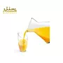ریختن آب پرتقال تازه در لیوان شیشه‌ای از یک پارچ شفاف با طراحی مدرن.