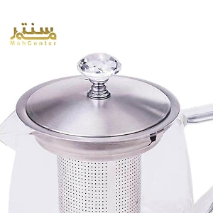 یک قوری شیشه ای با نام تجاری مه سنتر با یک درب شیشه ای و یک دسته.