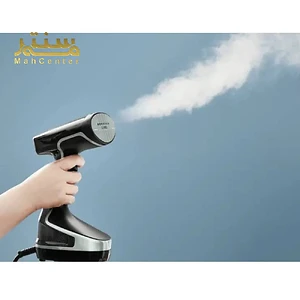 دستگاه بخارگر تفال در حال تولید بخار، نگه‌داشته‌شده در دست.