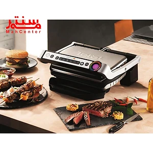 گریل تفال 712d28 که روی صفحه آشپزخانه قرار دارد و کنار آن یک صفحه قرار دارد و روی آن استیک پخته قرارد دارد که 3 برش از آن جدا شده.